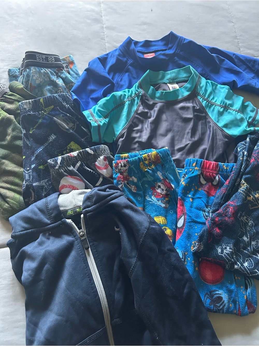 Boys 4T bundle. 7 pj bottoms. 2 swim tops. 1 hoodie jacket-Nike.